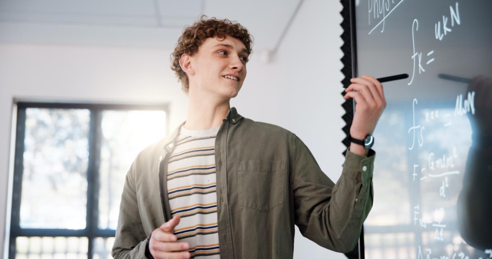 Image of a confident young person smiling while giving a presentation.